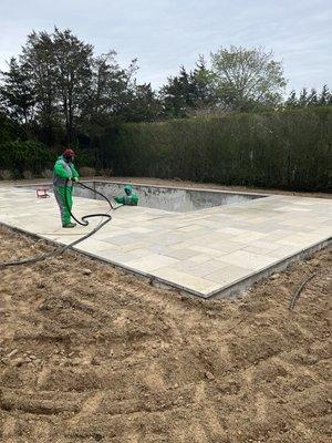 Blasting patio stone around pool