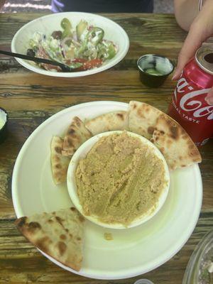 Hummus and Greek salad half eaten.