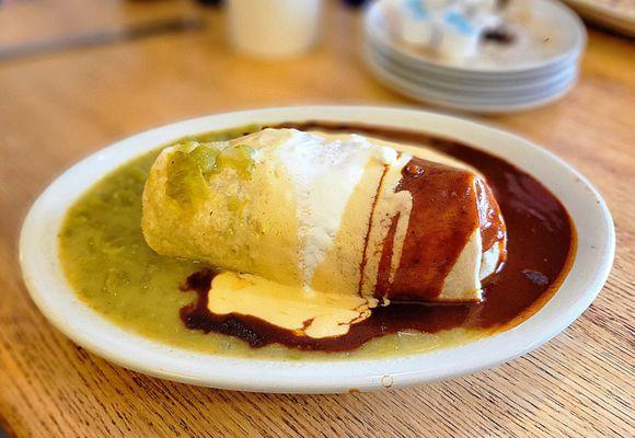 Doozy Burrito smothered and covered with red and green chiles and queso.