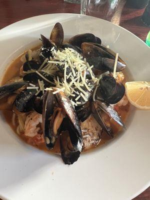 Delectable seafood linguine (mussels, scallops, shrimp with made from scratch pasta) in light red sauce.