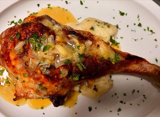 Stuffed long bone pork chop apples, gruyere cheese onions, breadcrumb topped with a hot honey mustard, pork Demi