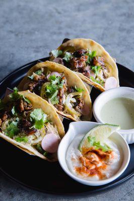 Smoked pork butt marinated in mojo sauce, topped with crispy chicharrones, pickled jalapeños, radish, and fresh cilantro.