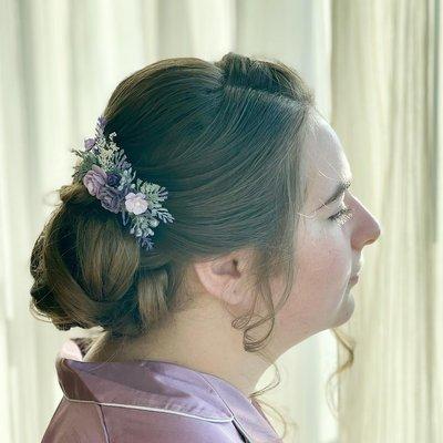 updo with a little flower detail on the side of updo