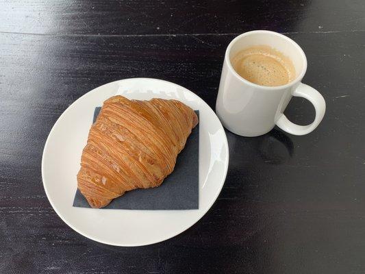 Coffee and a fresh croissant baked in the store each morning