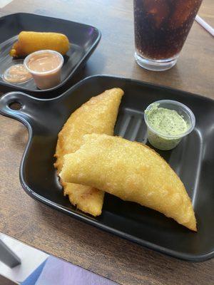 Empanadas and a cheese wrapped in masa then fried'