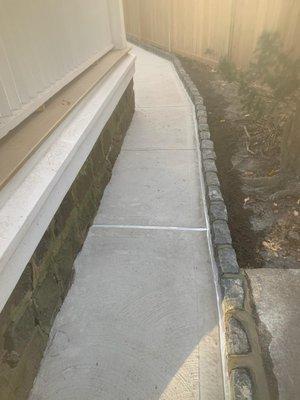 Concrete walkways with cobblestone edge installation by Bianco's Landscaping & Masonry.
Supplies by Staten Mix.