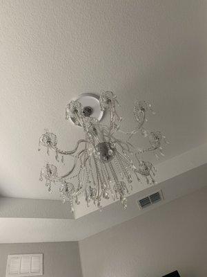 The chandelier removed from the old apartment and hung up at the new place.