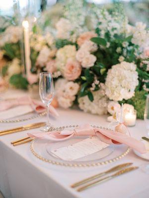 Floral centerpiece blush and white with candlelight