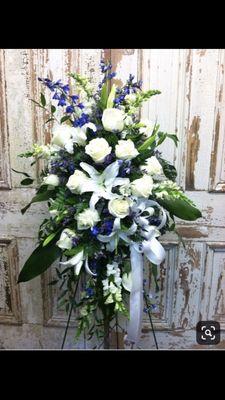 Sympathy easel with oriental lilies, roses and blue delphiniums