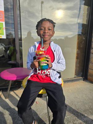 Lil man enjoying his rainbow slushie