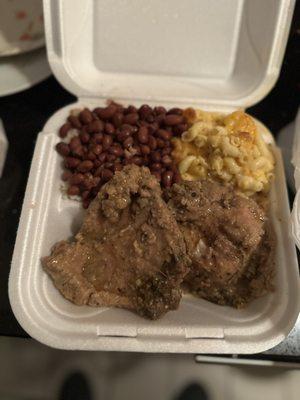 Smothered pork chop with Mac & cheese and red beans & rice.