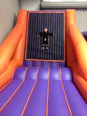 Have a sticky good time, jumping on the Velcro wall