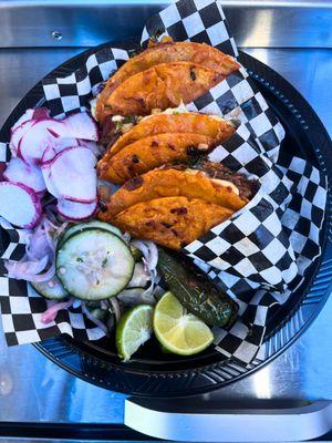 3x birria tacos order that includes onions, cilantro, lemon, jalapeno, pickled cucumbers, radish, green salsa and red salsa