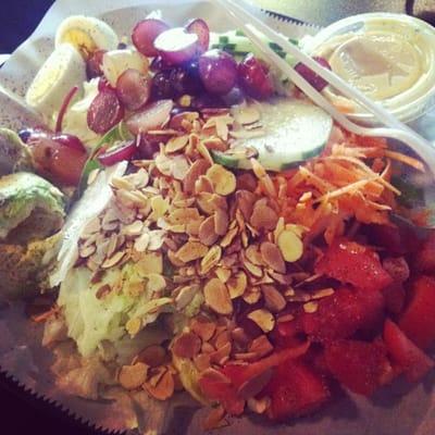 House salad with grapes, tomatoes, avocado, boiled eggs, cucumber, almonds, and ranch dressing