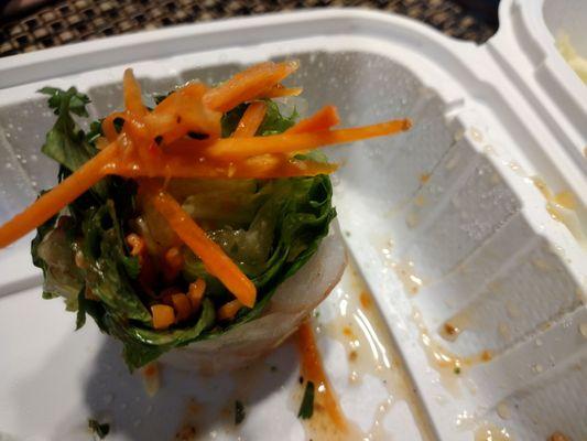 shrimp spring roll dipped in peanut sauce with carrot strips