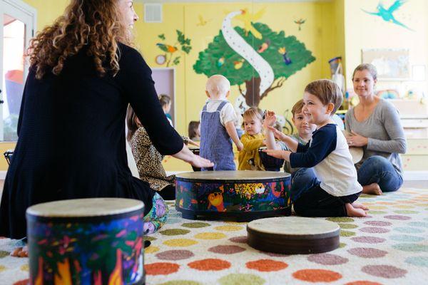 Alex A. teaching children about drumming.