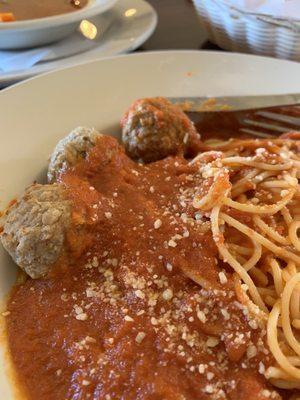 Spaghetti with gray meatballs