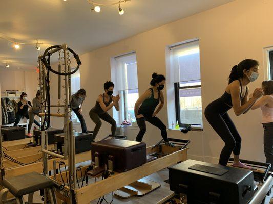 Standing Side Split Exercise in Group Reformer Class