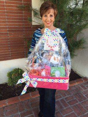 Pastor Cathy Guerrero holding a Life Builder Seminars' raffle basket.