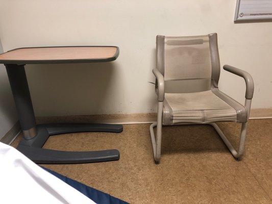 There's a table and chair. Amenities are the usual for an emergency room bay.