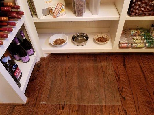 Create a dining shelf for your pets in the pantry.  ExactMats clear floor protector.