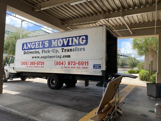 The Angel's Moving truck unloading our furniture to place into our unit at Public Storage.