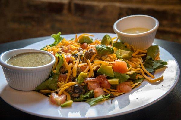 Turkey Santa Fe Taco Salad 
 Mixed greens, southwest seasoned ground turkey w/black beans and corn, shredded cheese, tomatoes, avocado
 and