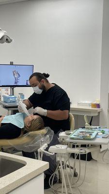 Ben Dental Assistant showing his skill with the scanner a much faster process than traditional impressions.