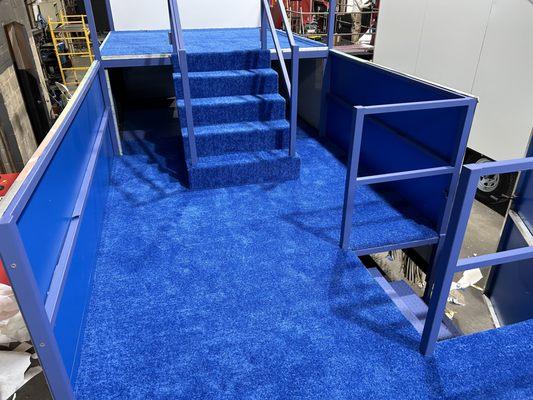 Commercial blue carpet installed on float