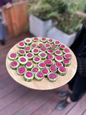 Wedding appetizer of beet hummus in cucumber cups