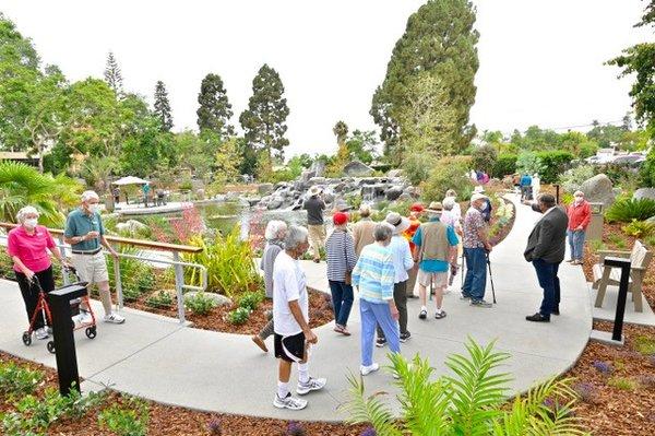 Residents enjoy the opening of Fredericka Manor's new pond.