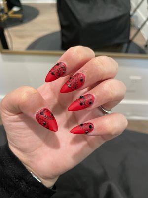 new nails, bold matte red with black lacey details and black gemstones