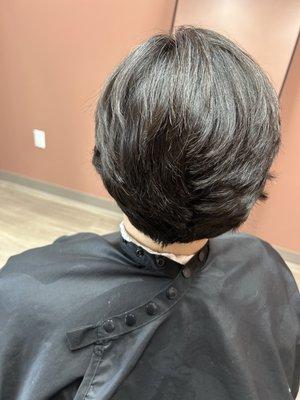 Short-layered haircut with taper.