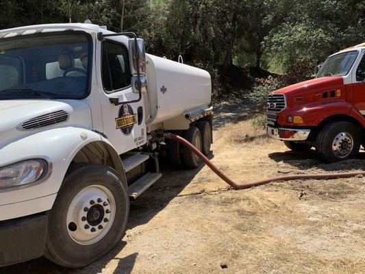 Boots Trucking assisting firefighters on the Carmel Fire