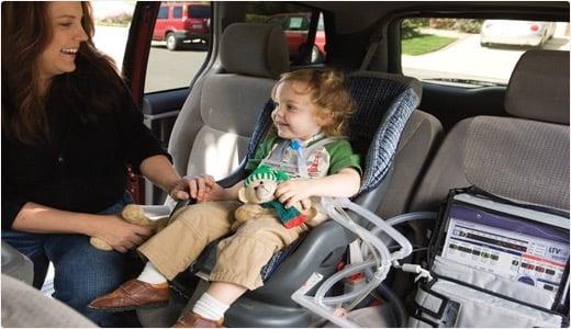 Young child on a ventilator being transported