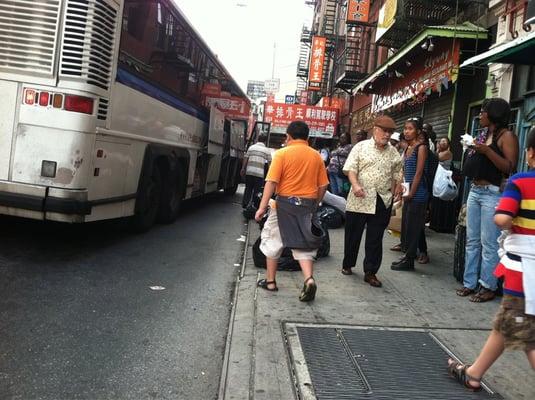 Right next to another bus station, ppl scramble to get on the bus, hope it's the right one!