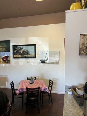 Beautiful local art + shadow on the wall, depicting cafe name