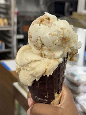 2 scoops on a chocolate cone. (Biscoff scoop, caramel pretzel scoop)