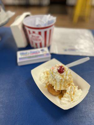 Homemade ice cream and mini donut sundae topped with real maple syrup, whipped cream, and a cherry!