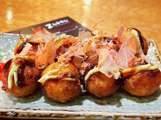 Tako Yaki fried octopus wheat flour balls with sauces on top.