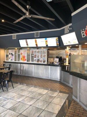 Front ordering area. Menus are displayed on TV screens.