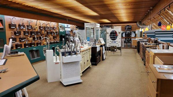 Plumbing fixtures on left, cabinets and hardware  in center