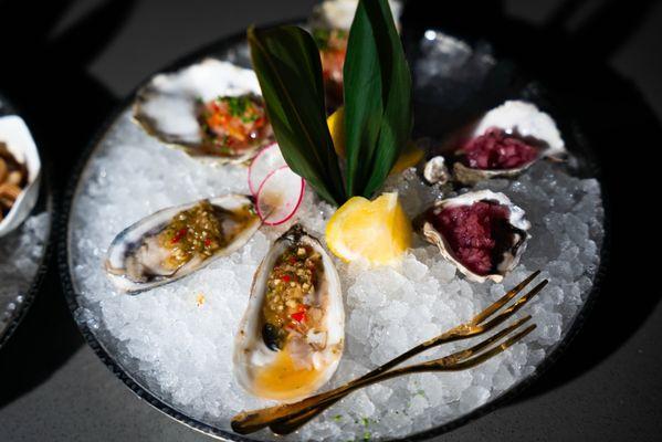 Oysters with anchovy chili sauce and red wine mignonette.