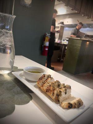 Bread with rosemary topping and olive oil with a splash of balsamic vinegar