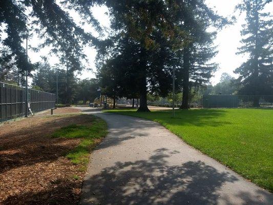 pathway separating the courts from the baseball field