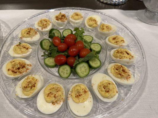 Deviled eggs with English cucumbers and cherry tomatoes