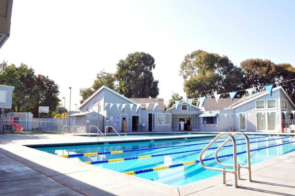 Poolside with main building visible. Barbeque  area and playground not pictured.