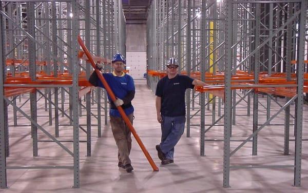 Shelving Inc. installation team hard at work in a warehouse and manufacturing facility.