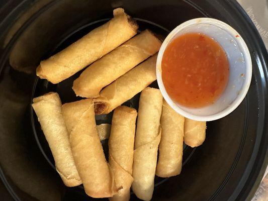 Chicken lumpia (fried spring rolls) with sweet chili sauce. Served as an appetizer.