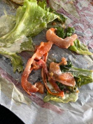 What is this  destroyed tomato and wilted lettuce that smelled inside the sandwich.